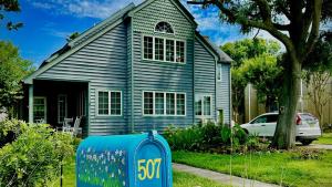 a house with a blue mailbox in front of a house at Pet Friendly And Steps To The Bay in Villas