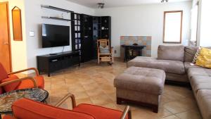 a living room with a couch and a tv at Pet Friendly And Steps To The Bay in Villas