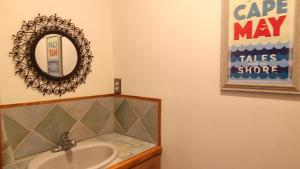 a bathroom with a sink and a mirror at Pet Friendly And Steps To The Bay in Villas +29 photos