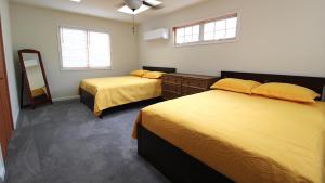 a bedroom with two beds and a dresser and a mirror at Pet Friendly And Steps To The Bay in Villas