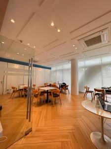 a large room with wooden tables and chairs at Cloud Haven Suite at Azure North Pampanga in San Fernando