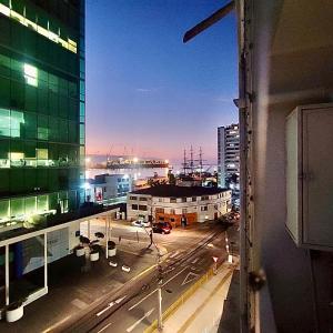 a view of a city at night from a window at Edificio Lynch- Sector Centro Depto Full Equipado 2D2B Estacionamiento in Iquique +9 photos
