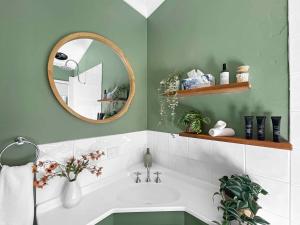 a bathroom with a sink and a mirror at Bimbadeen Estate Villa 1 in Mount View +4 photos