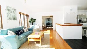 a living room with a blue couch and a table at 505 Sandalwood Road in Wildwood Highlands Beach