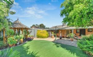 a backyard with a lawn and a gazebo at Private 4BR Garden Haven - Spacious & Serene in Mawson Lakes