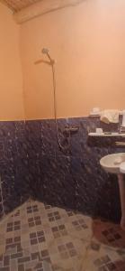 a bathroom with a shower and a sink at ZAZA Guest house in Agoudal