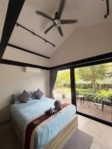 a bedroom with a bed and a ceiling fan at 913 Luxury Pool Villa Khaolak in Khao Lak +35 photos