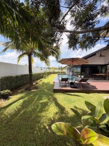 a view of the yard of a house with a palm tree at 913 Luxury Pool Villa Khaolak in Khao Lak