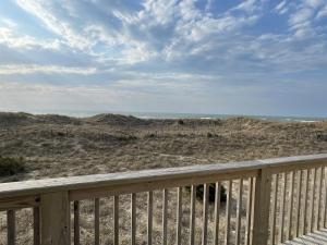 a view of the beach from the deck of a house at 57151 Lighthouse Rd Home in Hatteras
