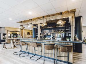 a bar at a restaurant with stools at ibis Styles Contres-Cheverny in Le Controis En Sologne