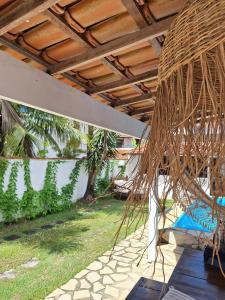 a patio with a hammock and a palm tree at El refugio in Búzios