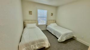 a bedroom with two beds and a window at Modern Luxury Haven in Colorado Springs