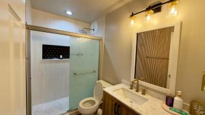 a bathroom with a shower and a toilet and a sink at Modern Luxury Haven in Colorado Springs +18 photos
