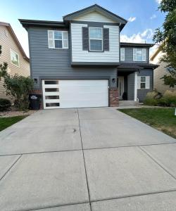 a house with a white garage door on a driveway at Modern Luxury Haven in Colorado Springs