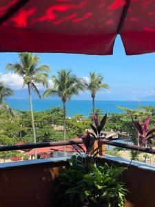 a view of the ocean from the balcony of a resort at Pousada Sol e Cia Tur in Caraguatatuba