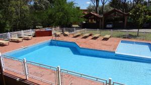 a large swimming pool with lounge chairs at Posada Merlo in Merlo