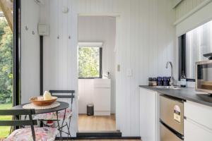 a kitchen with a table with a bowl on it at Deloraine Tiny Retreat by Tiny Away in Whangarei