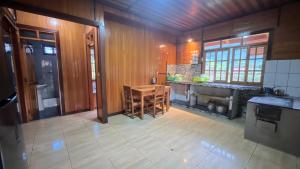 a kitchen with a table and a counter top at CABAÑA RaNCH OXAPAMPA in Oxapampa +24 photos