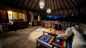 a living room with a couch and a table at Hotel Paraiso Escondido in Puerto Escondido