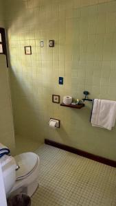 a bathroom with a toilet and towels on the wall at Hotel Paraiso Escondido in Puerto Escondido +26 photos