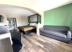 a hotel room with a bed and a couch at Super 8 by Wyndham Marianna I-10 in Marianna