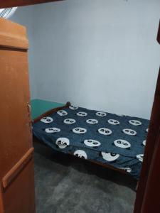 a bedroom with a bed with panda face sheets at Alumpara House - Home Stay in Palakkad