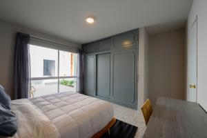 a bedroom with a bed and a large window at MATAMOROS 2 · Refugio Céntrico con Piscina in Oaxaca City