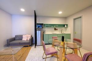 a living room with a glass table and a couch at MATAMOROS 2 · Refugio Céntrico con Piscina in Oaxaca City