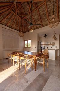 a dining room with a large wooden table and chairs at PH POINTE · Luxury Penthouse with Pool in Brisas de Zicatela