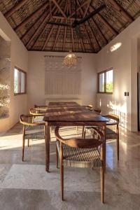 a dining room with a table and chairs at PH POINTE · Luxury Penthouse with Pool in Brisas de Zicatela +2 photos