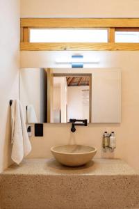 a bathroom with a sink with a large bowl at PH POINTE · Luxury Penthouse with Pool in Brisas de Zicatela