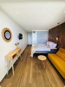 a bedroom with a large bed and a couch at 412 The Diamond Swing in Le Diamant +36 photos