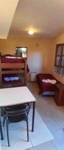 a room with a bed and a table in a room at Posada Merlo in Merlo