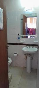 a bathroom with a sink and a toilet and a mirror at Posada Merlo in Merlo +5 photos