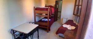 a small room with a room with a table and a chair at Posada Merlo in Merlo