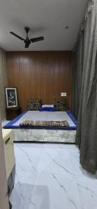 a bedroom with a bed and a ceiling fan at Home stays in Jammu