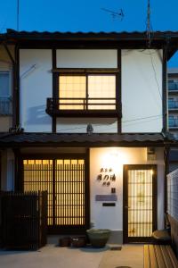a building with two doors and a window at Kyotoya Tsuki no Yu Bettei in Kyoto