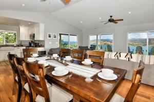 a kitchen and dining room with a wooden table and chairs at Vineyard Setting With 180 Panoramic Lake Views in Lower Lake