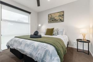 a bedroom with a large bed and a window at The Red Door in Martinborough