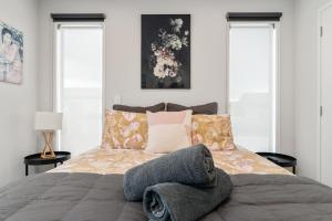 a bedroom with a large bed with pillows at The Red Door in Martinborough
