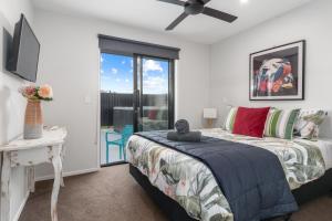 a bedroom with a bed and a ceiling fan at The Red Door in Martinborough