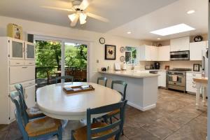 a kitchen with a table and chairs and a kitchen with a dining room at Heron House - Hot Tub And Wine Tastings Included in Healdsburg
