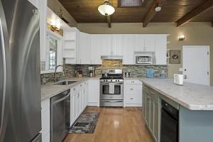 a kitchen with white cabinets and a stove top oven at River View Lodge - Hot Tub And Tastings Included in Healdsburg