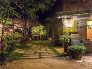 a walkway in front of a building at night at Pai Country Hut in Pai