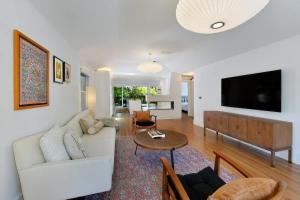 a living room with a white couch and a table at Fitch St Escape - Wine Tastings Included in Healdsburg