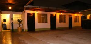 a room with a white building with black doors at La Casa del Barrio in Quetzaltenango