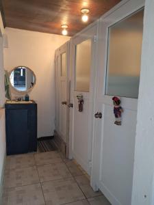 a hallway with a door and a mirror at La Casa del Barrio in Quetzaltenango