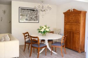 a dining room with a table and chairs and a chandelier at Las Condes familiar Deluxe in Santiago +9 photos