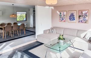 a living room with a couch and a table at 3 Bedroom Beautiful Home In Asperup in Asperup