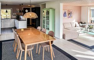 a kitchen and living room with a wooden table and chairs at 3 Bedroom Beautiful Home In Asperup in Asperup